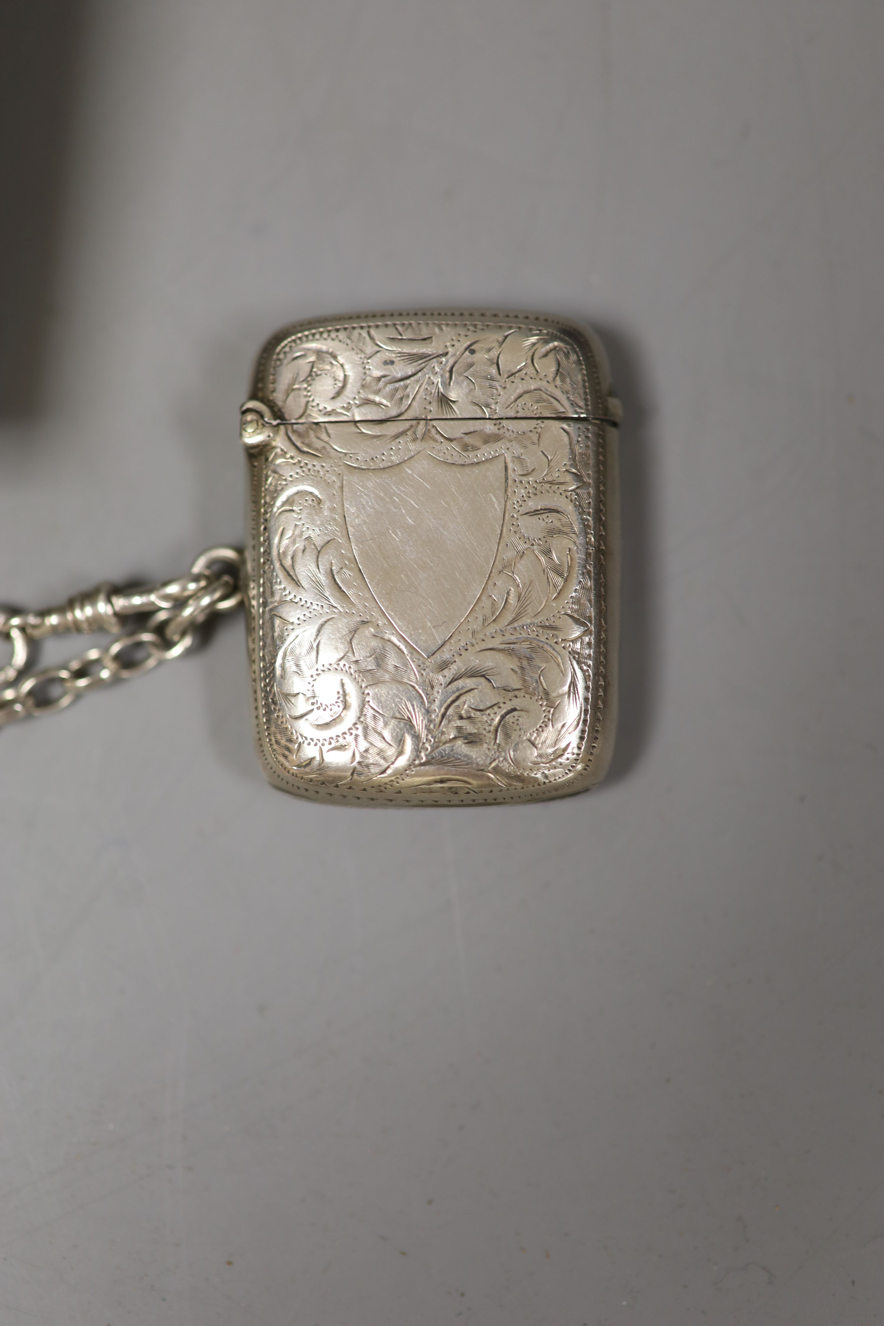 Four silver apostle spoons, a silver vesta case on chain and a silver medallion.